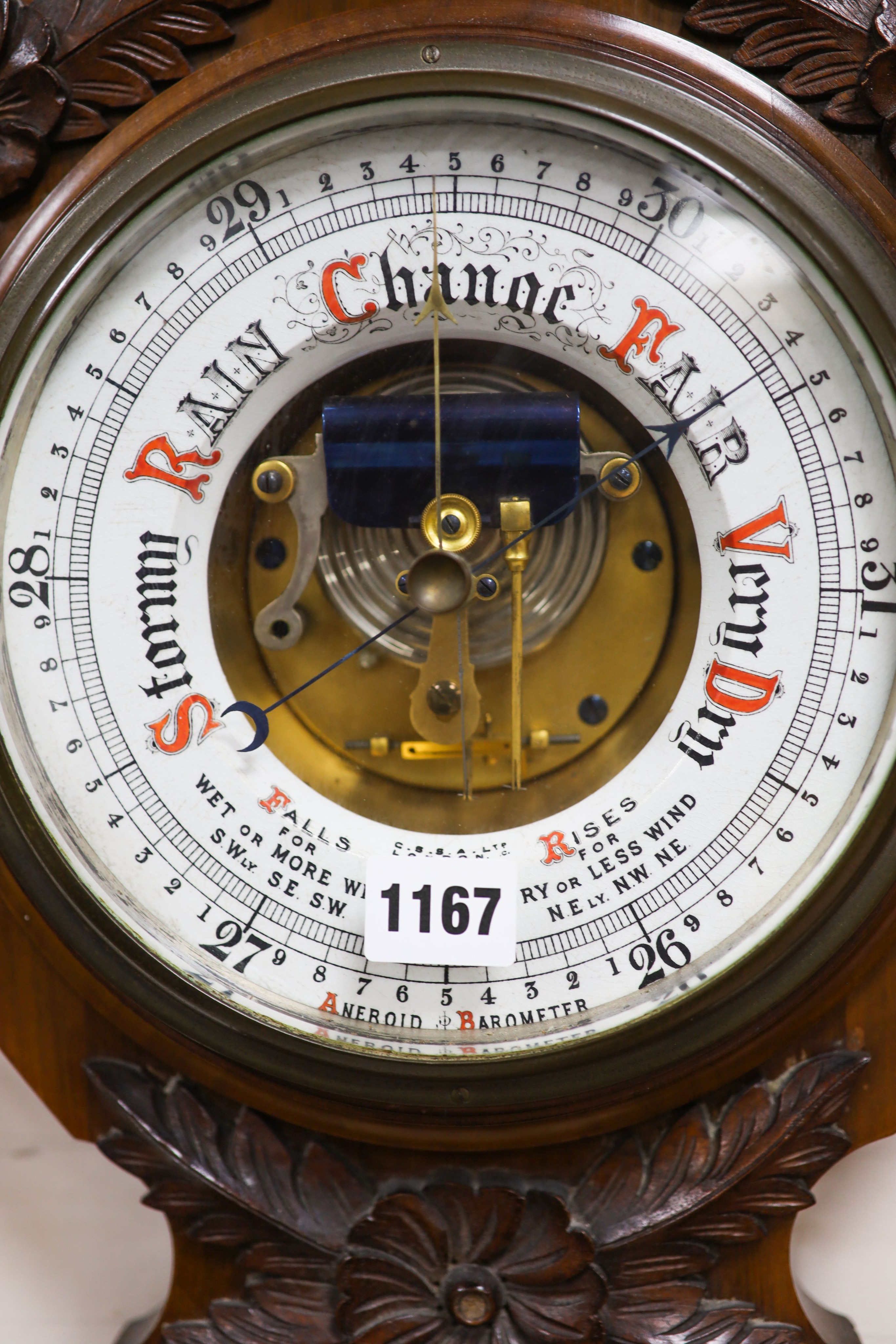 An Edwardian carved walnut cased aneroid barometer and thermometer, height 99cm